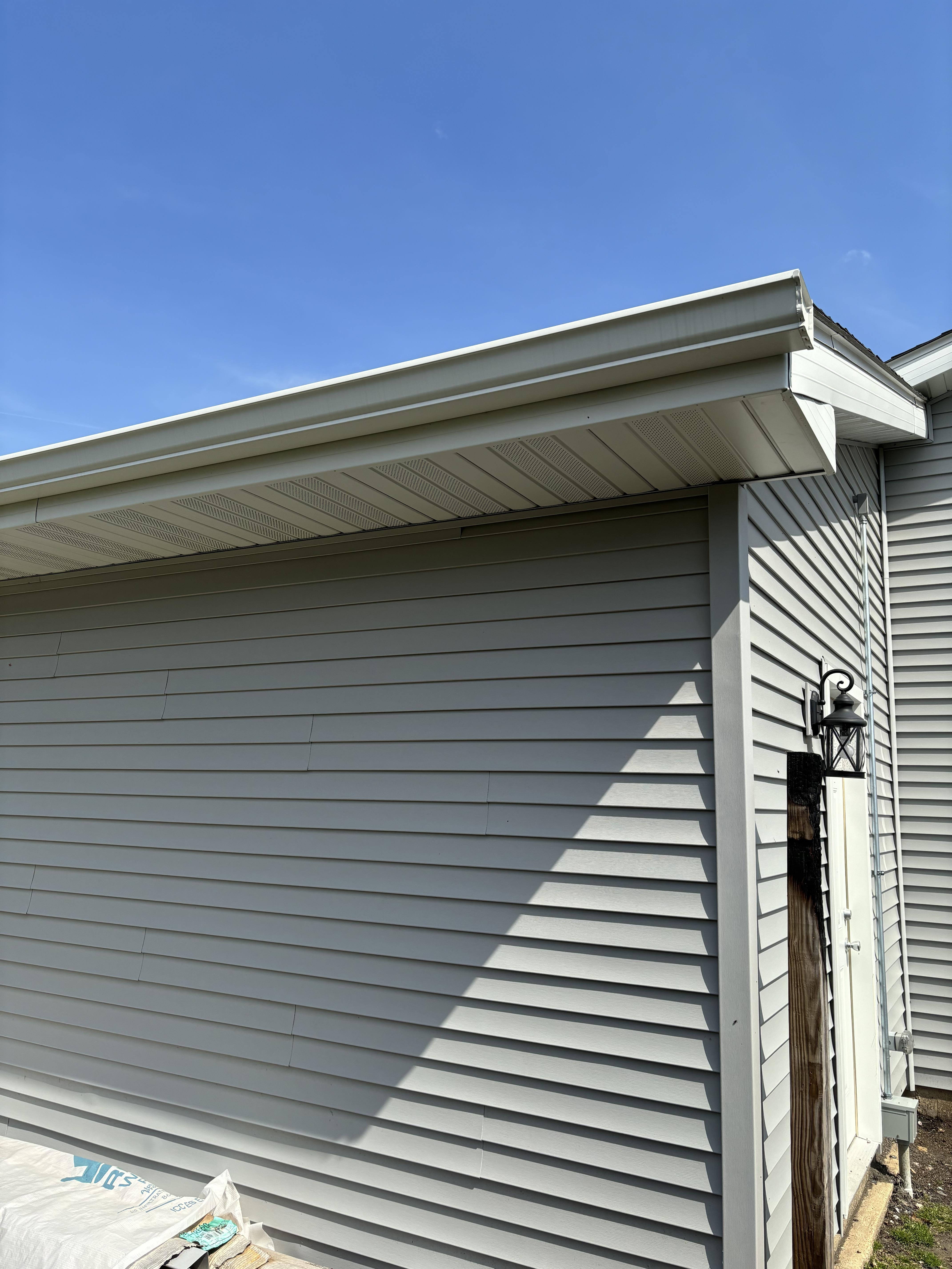 New Gutter System with Downspouts on Residential Home Freshly installed gutter system with downspouts on residential home